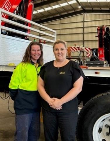 Woman apprentice with man wearing high visibility clothes