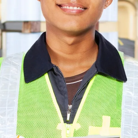 smiling young man printers print house Disability DIAP young man with clipboard book clothing engineer fashion accessory hard hat hat helmet human face laptop person wearing