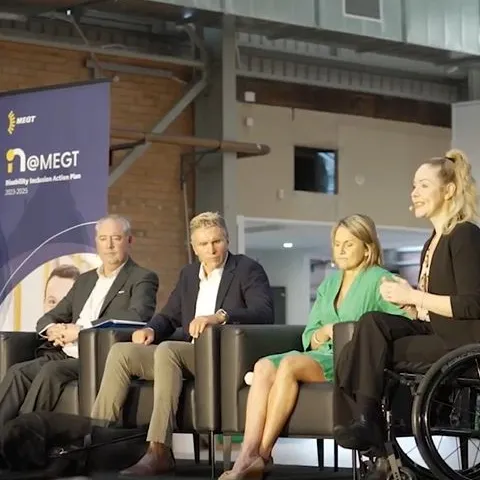 Disability DIAP MEGT panel discussion Disability Inclusion Action Plan woman with disability talking presenting to audience indoors building chair clothing footwear furniture indoor man people person suit wall wheelchair