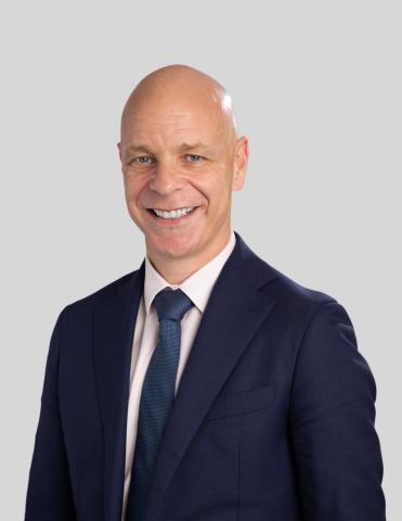 Executive Chris Dale MEGT clothing person man smile human face formal wear blazer collar dress shirt outerwear white-collar worker gentleman headshot businessperson shirt pocket dress suit button suit Chris Dale MEGT
