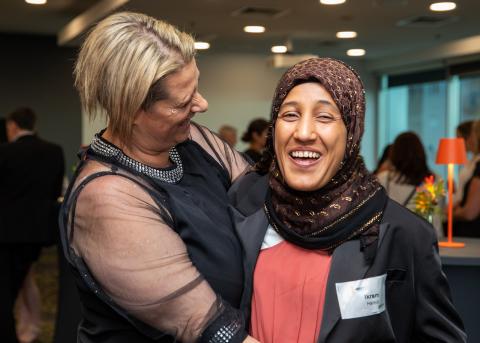 Two ladies hugging at the MEGT Scholarship Foundation graduation night