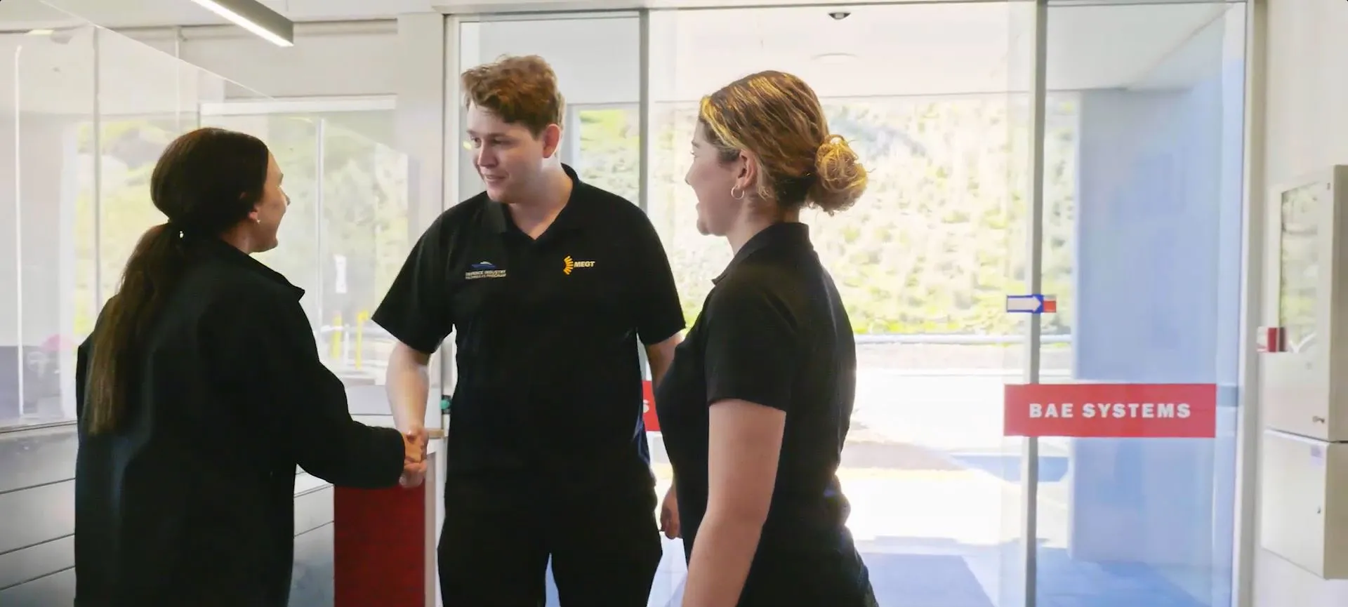 apprentice trainee host employer BAE systems programs we are recruiting for about partner programs young apprentice or trainee meeting employer colleague young man young woman clothing human face indoor job people person standing wall window woman