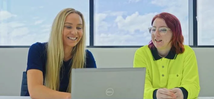 indoors IT young woman apprentice or trainee Employers How apprentices and trainees can grown your business RMS apprentice or trainee with employer sitting looking at laptop clothing computer human face indoor job laptop person smile woman