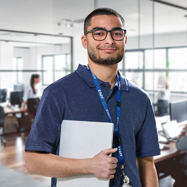 Man wearing glasses and lanyard smiling