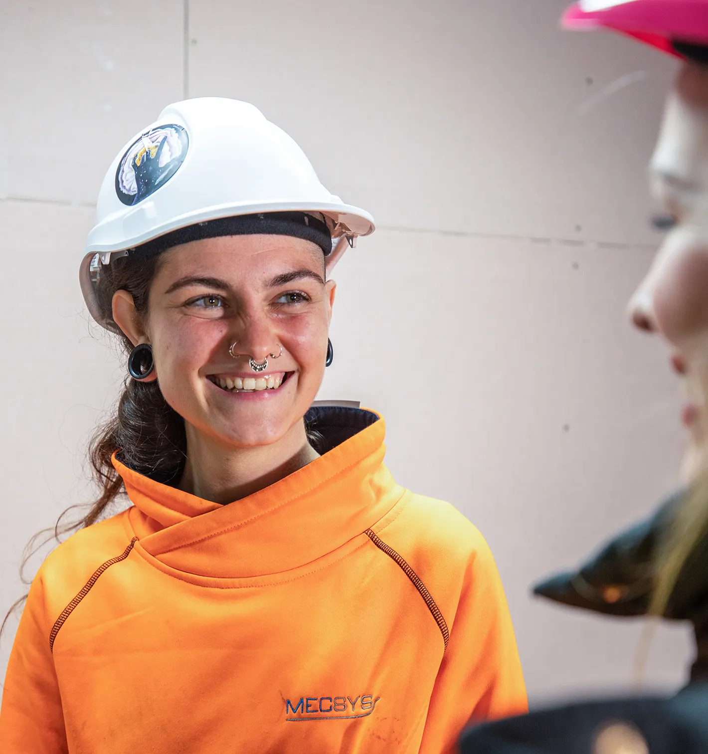 happy discussion indoors Employers Mentor Mentoring and Personal Support Services young woman construction apprentice or trainee with mentor blue-collar worker clothing engineer fashion accessory firefighter hard hat high-visibility clothing human face orange person personal protective equipment smile wearing workwear