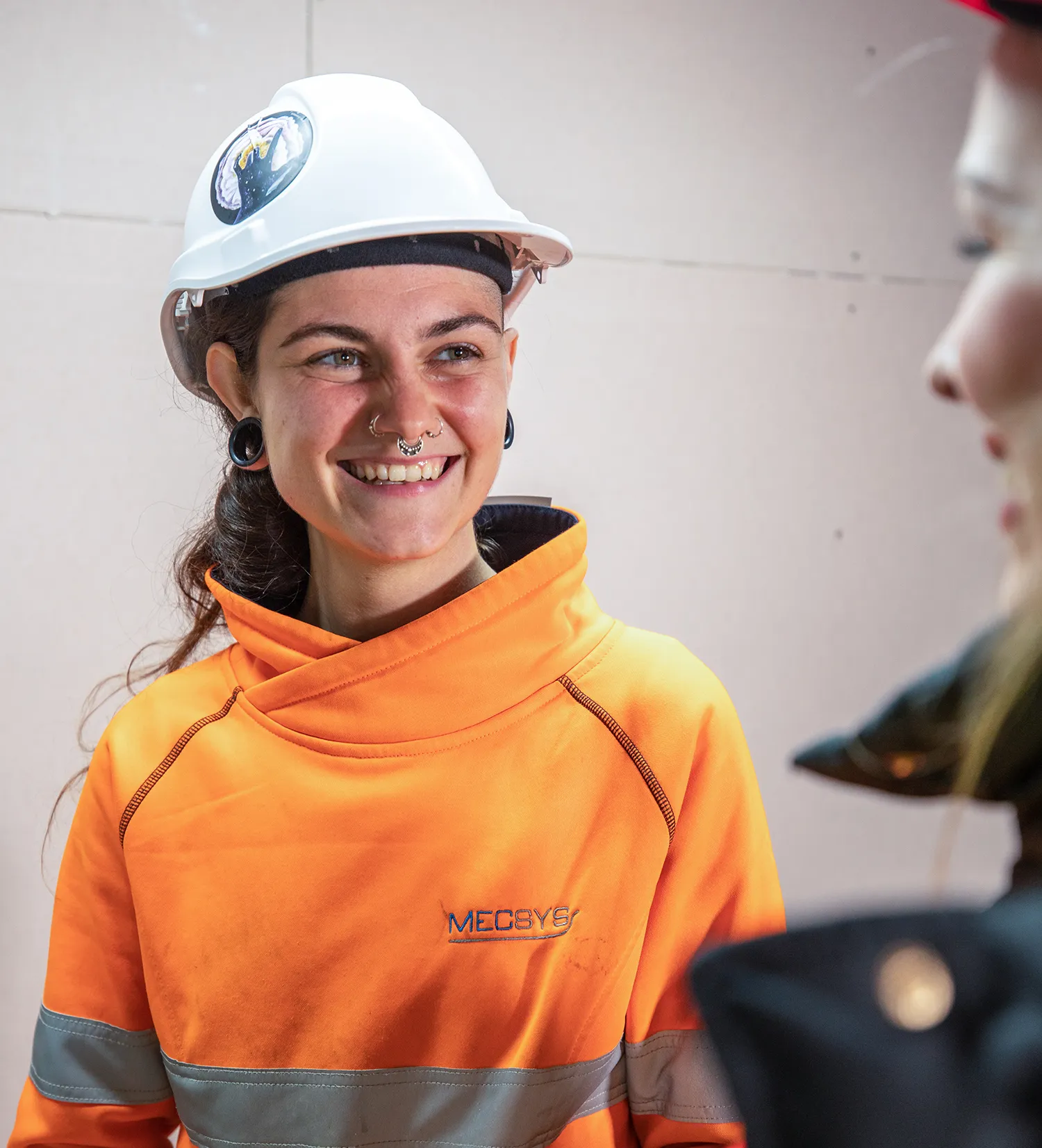 happy discussion indoors Employers Mentor Mentoring and Personal Support Services young woman construction apprentice or trainee with mentor blue-collar worker clothing engineer fashion accessory firefighter hard hat high-visibility clothing human face orange person personal protective equipment smile wearing workwear