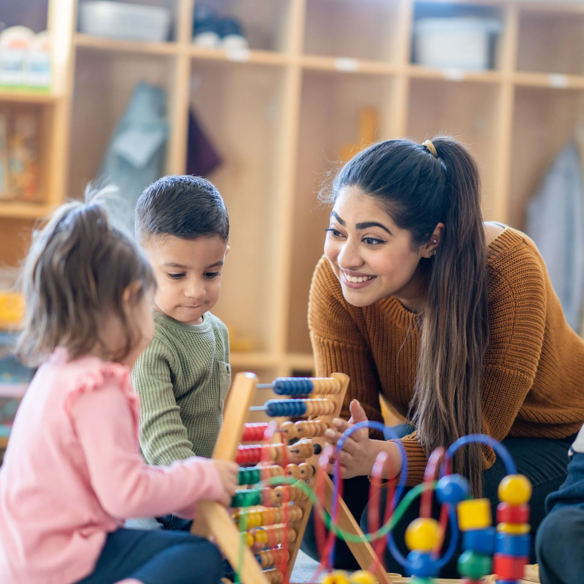 Childcare worker playing with children
