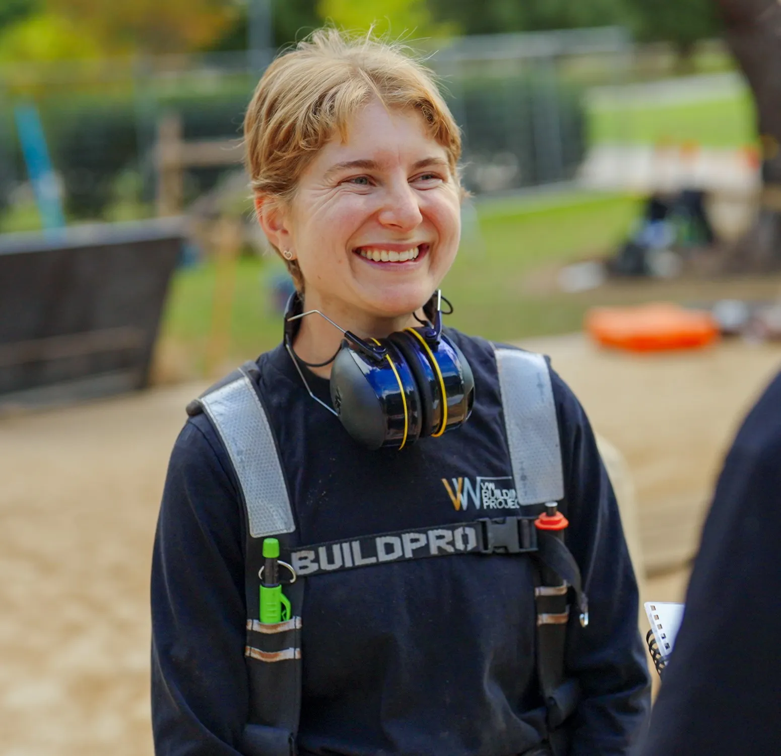 smiling woman in trade gear outdoors