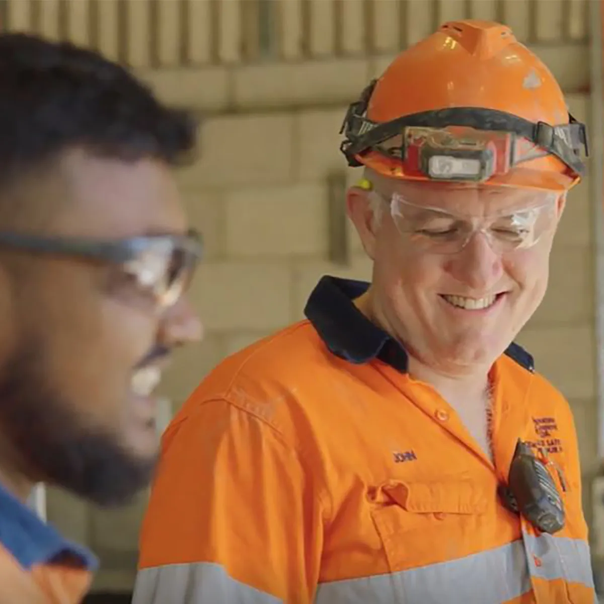 Two trades people on a work site